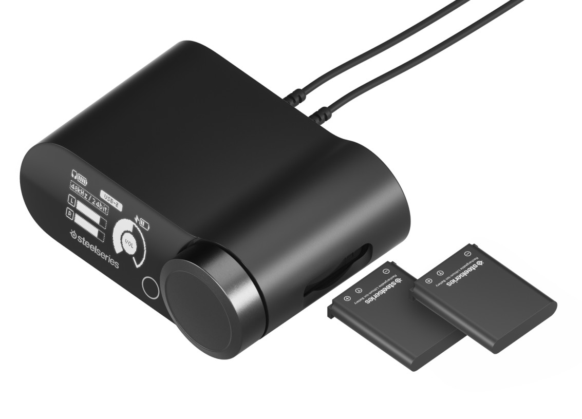 Czarne urządzenie audio z dwoma bateriami. Pokazuje głośność i ustawienia. Marka Steelseries.