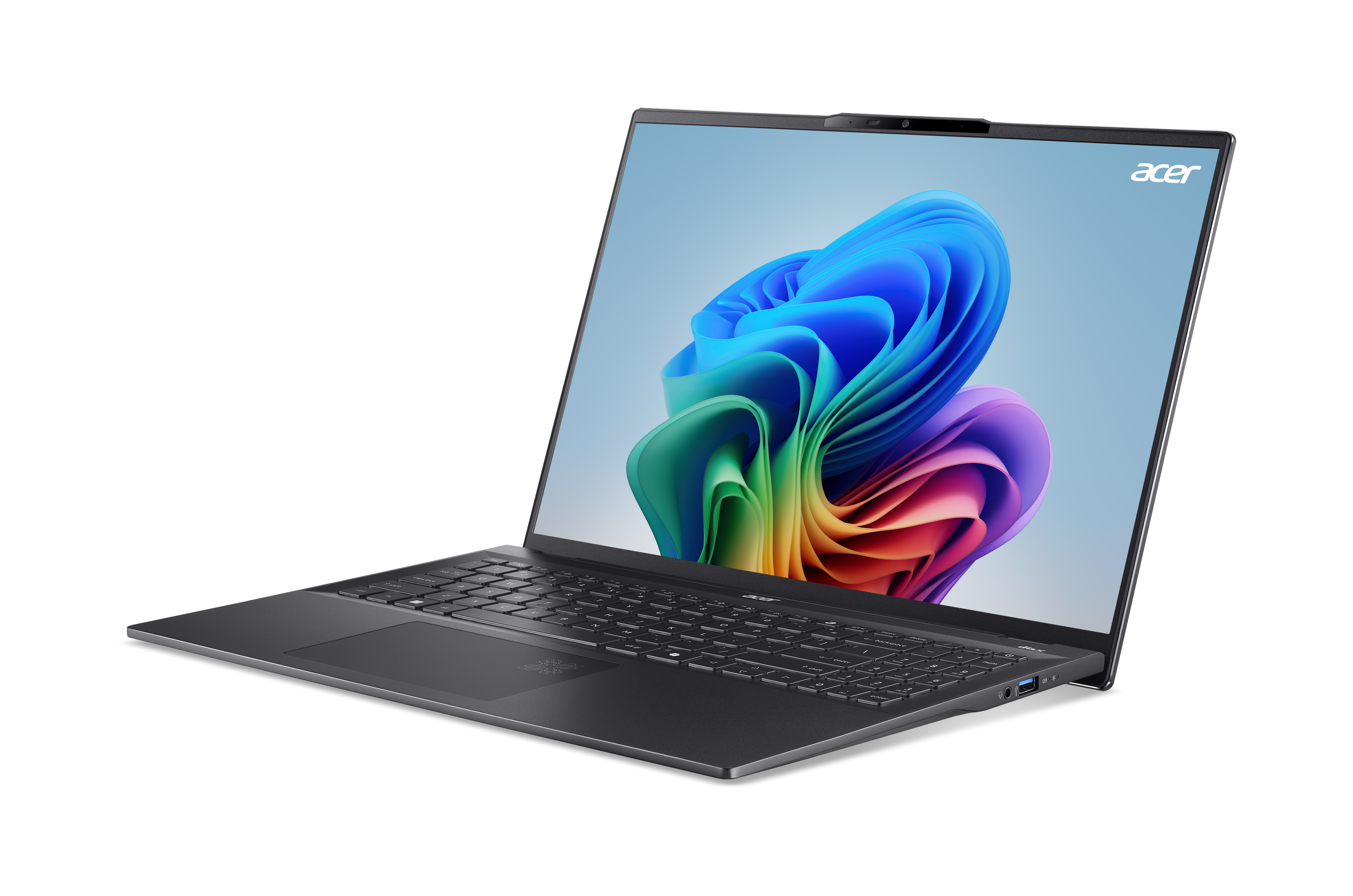 Ein dunkelgrauer Laptop, geöffnet, auf dunklem Hintergrund. Der Bildschirm zeigt ein farbenfrohes Bild.
