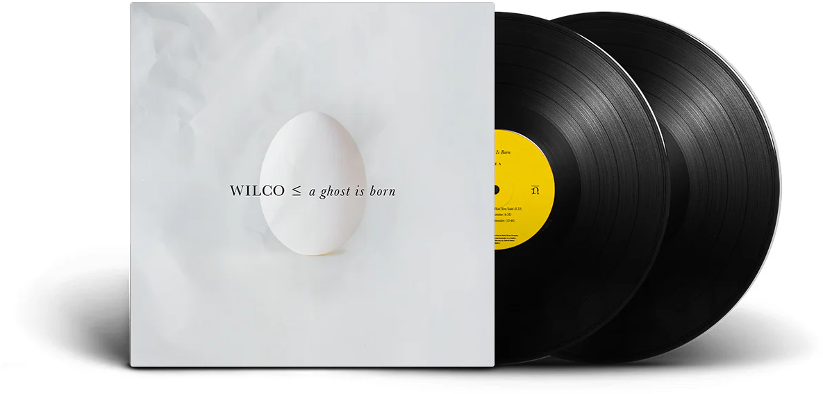 Wilco bakelit lemezalbum borítója tojással fehér háttéren és két fekete bakelit lemezzel.