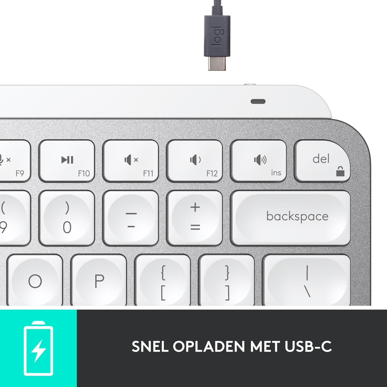 A keyboard with white keys and a USB-C cable.