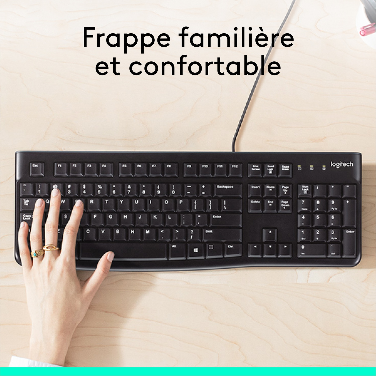 A hand typing on a black keyboard.