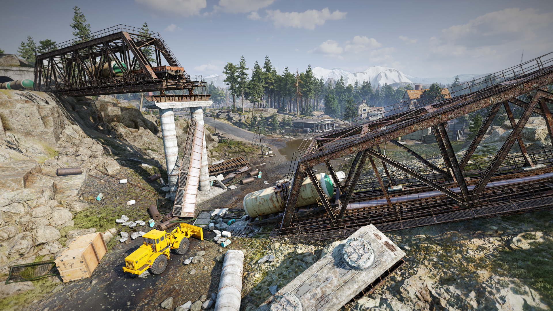 Gruz i żółty pojazd na zawalonym moście, z górami w tle.