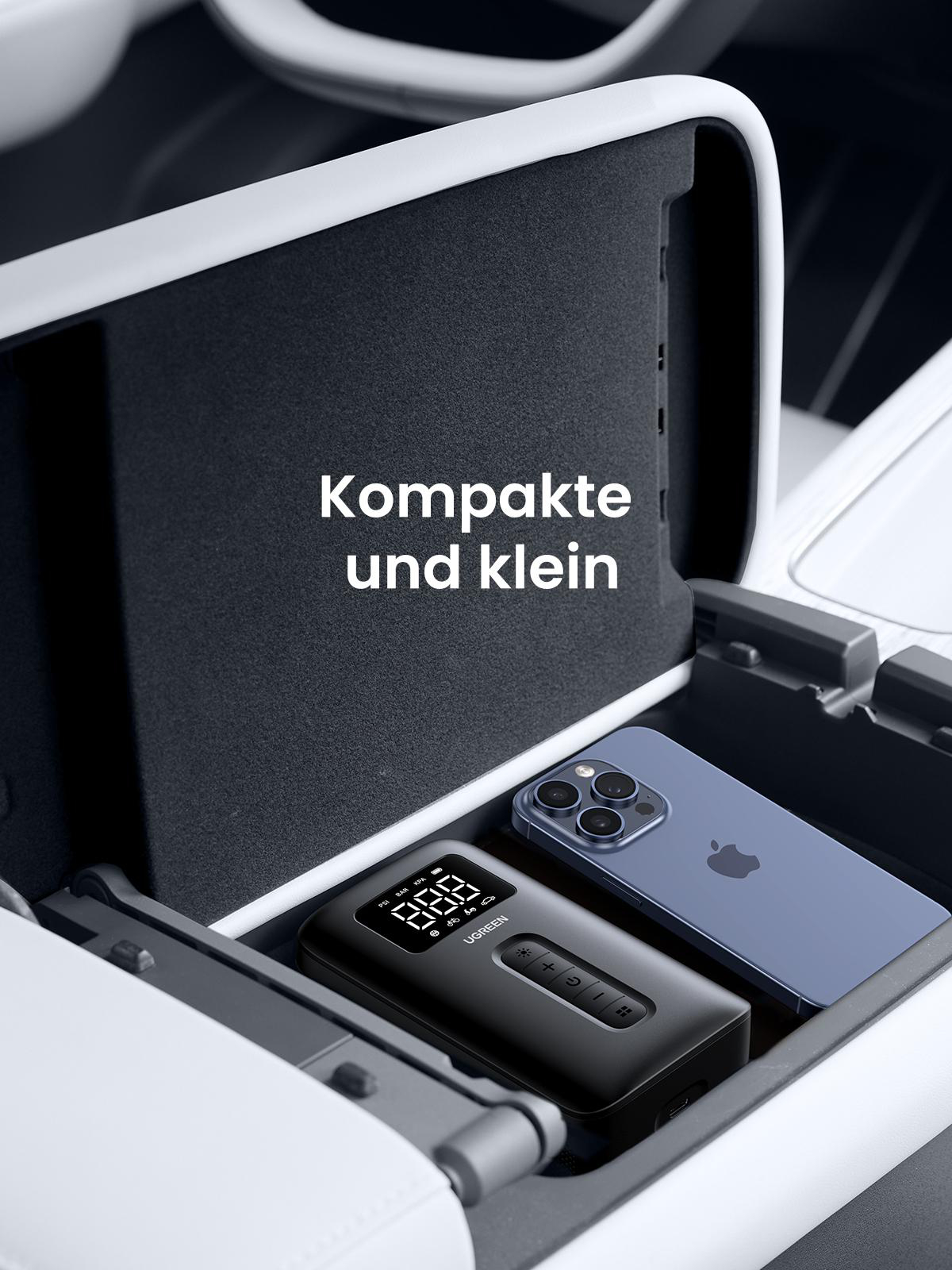 Autokonsole mit Telefon und einem schwarzen Gerät. Text: Kompakt und klein.