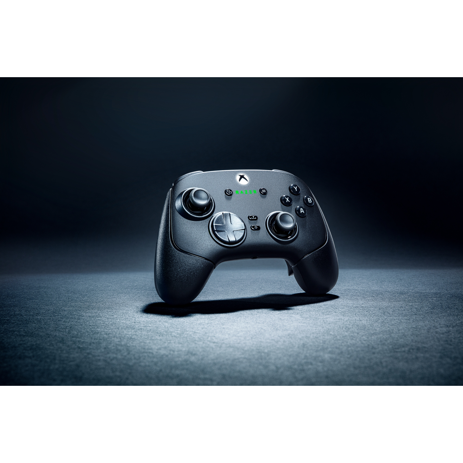A black game controller on a dark surface.