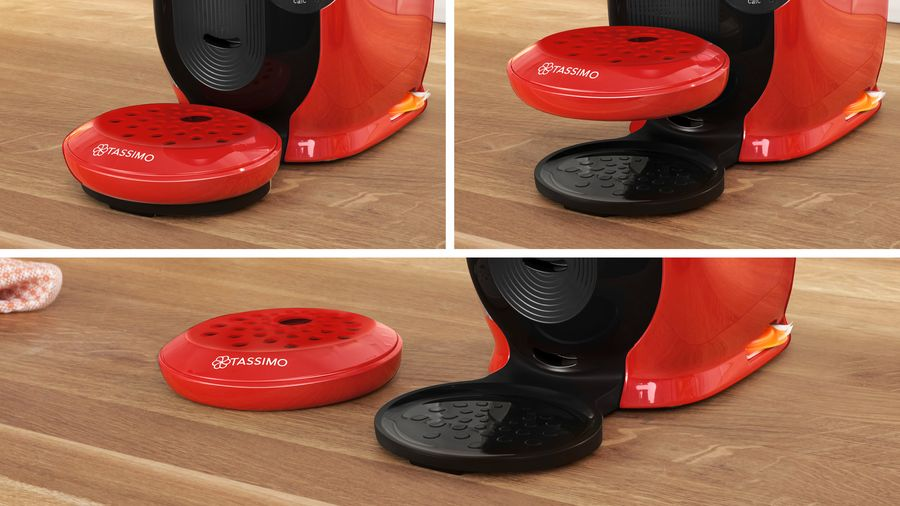 Una cafetera Tassimo roja con accesorios.