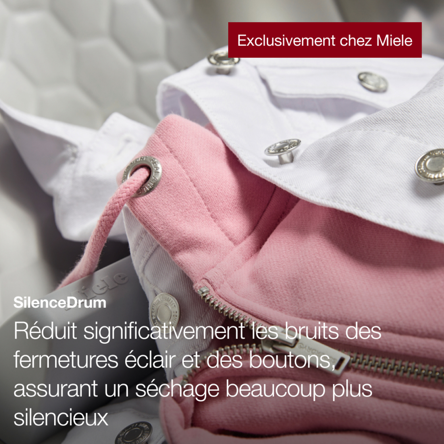 Gros plan sur des vêtements roses et blancs avec texte sur Silence Drum et fermeture éclair.
