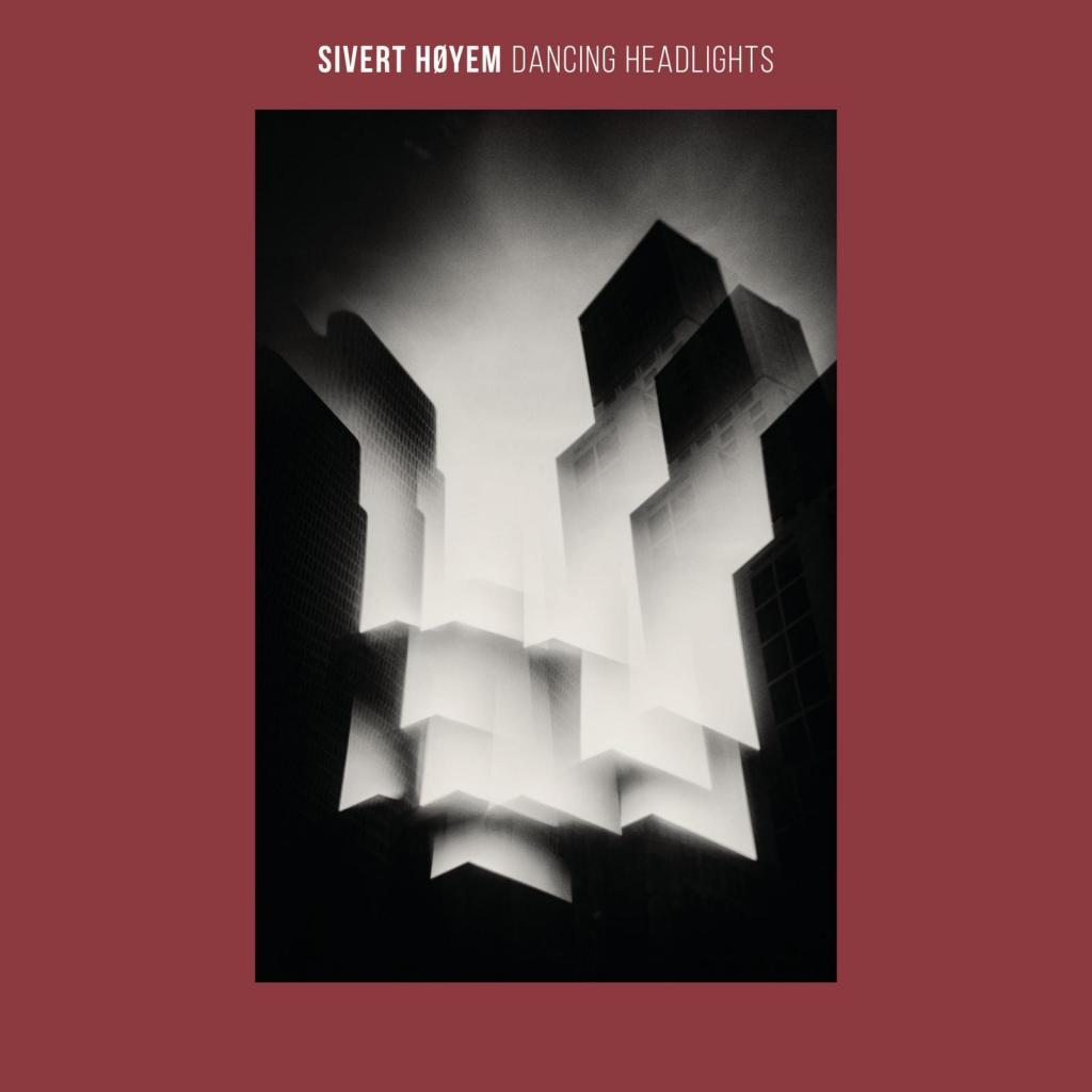 Albumcover. Schwarz-Weiß-Bild von hohen Gebäuden, mit dem Text 'SIVERT HØYEM' oben.