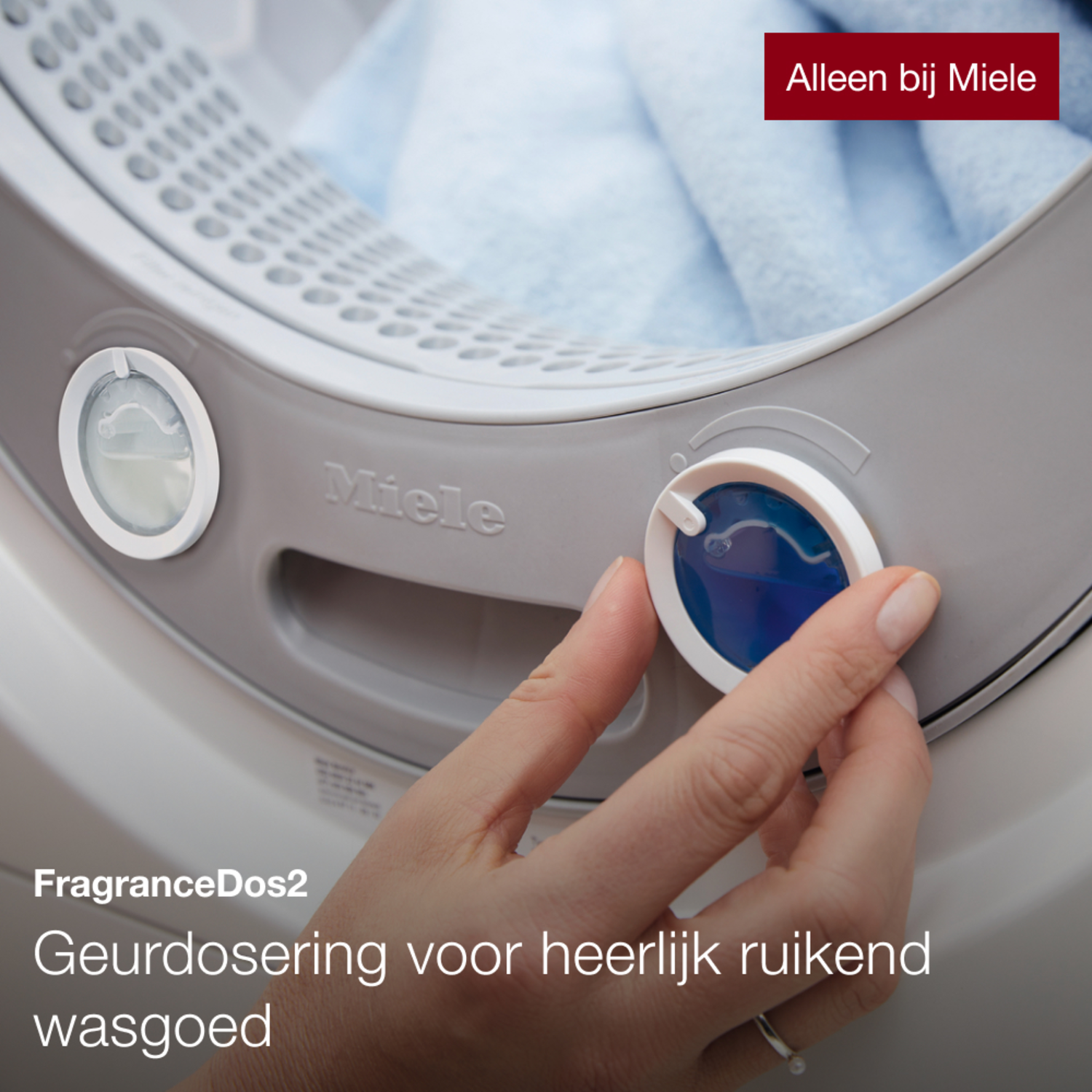 A hand turning a dial on a washing machine.