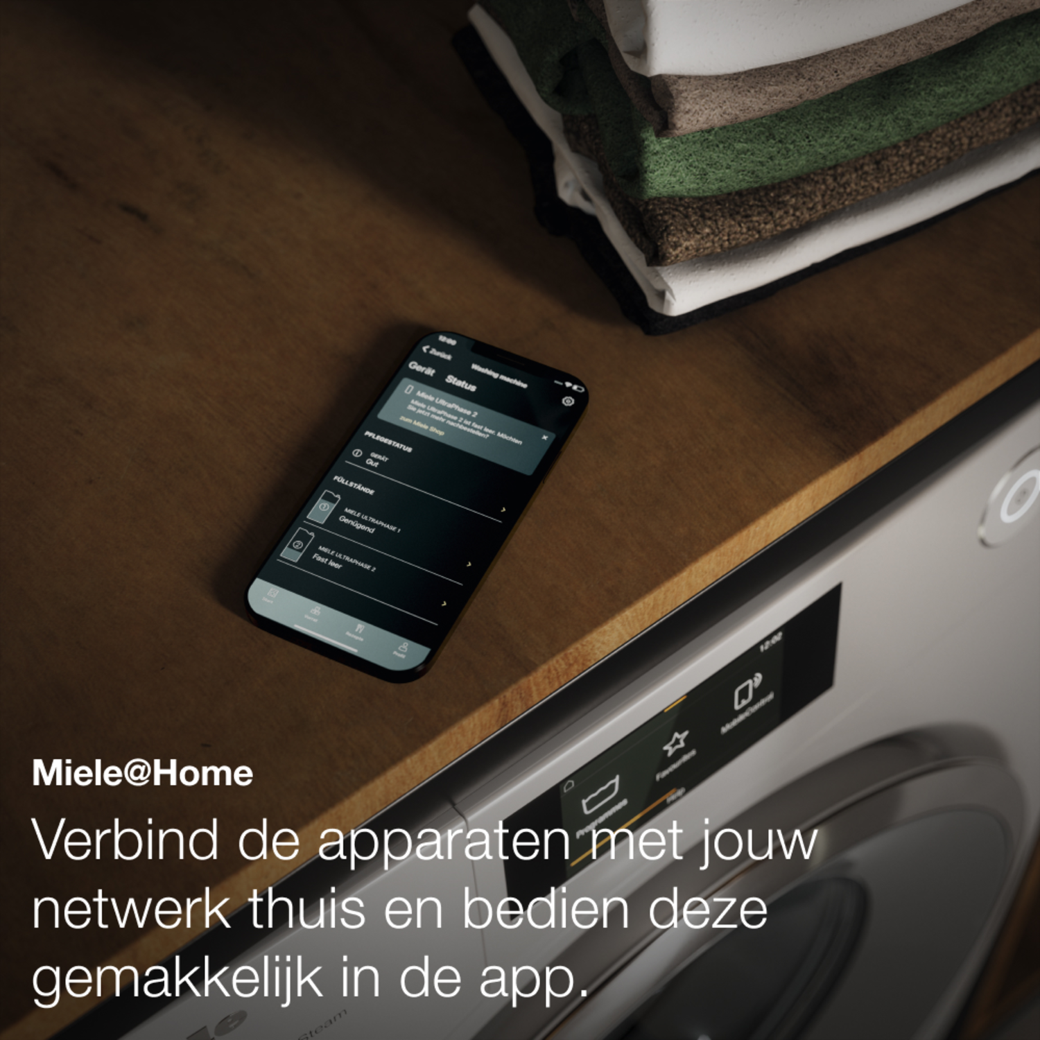 A washing machine with a smartphone on top displaying a control panel for the machine.