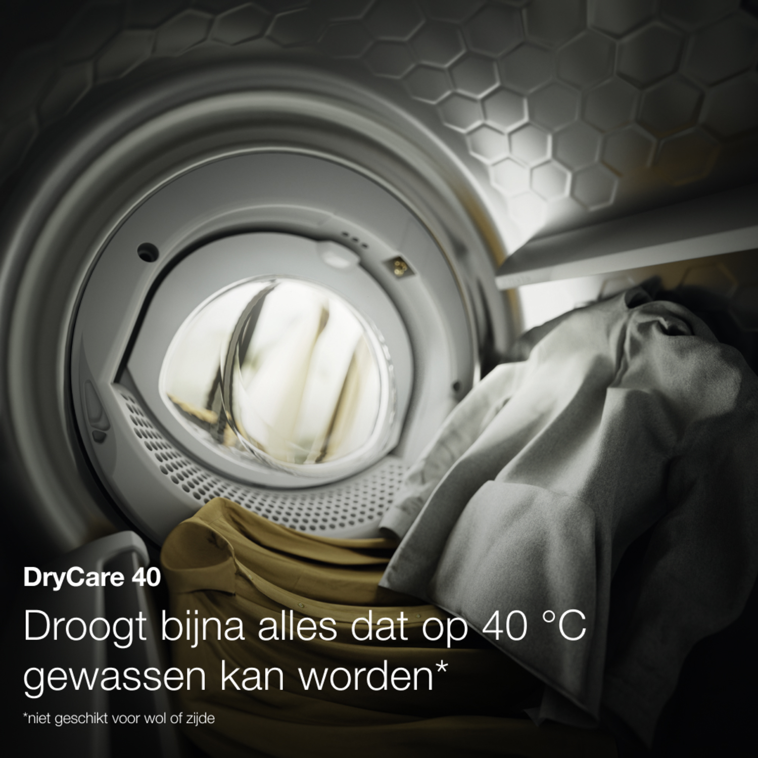 Clothes in a washing machine. The washing machine is in a silver metallic finish.