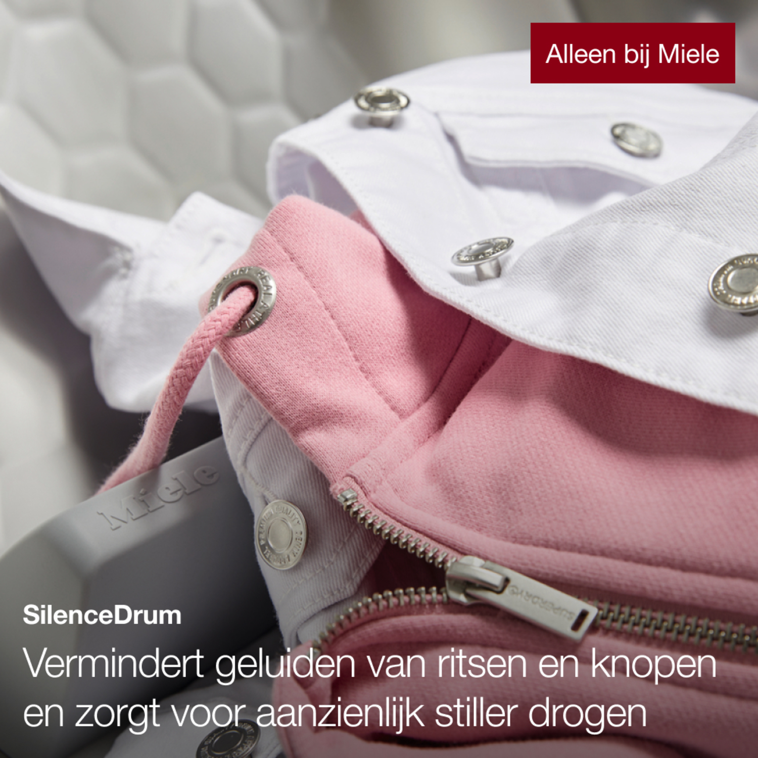 Close up of pink hoodie and white jacket inside a washing machine. Text: SilenceDrum.