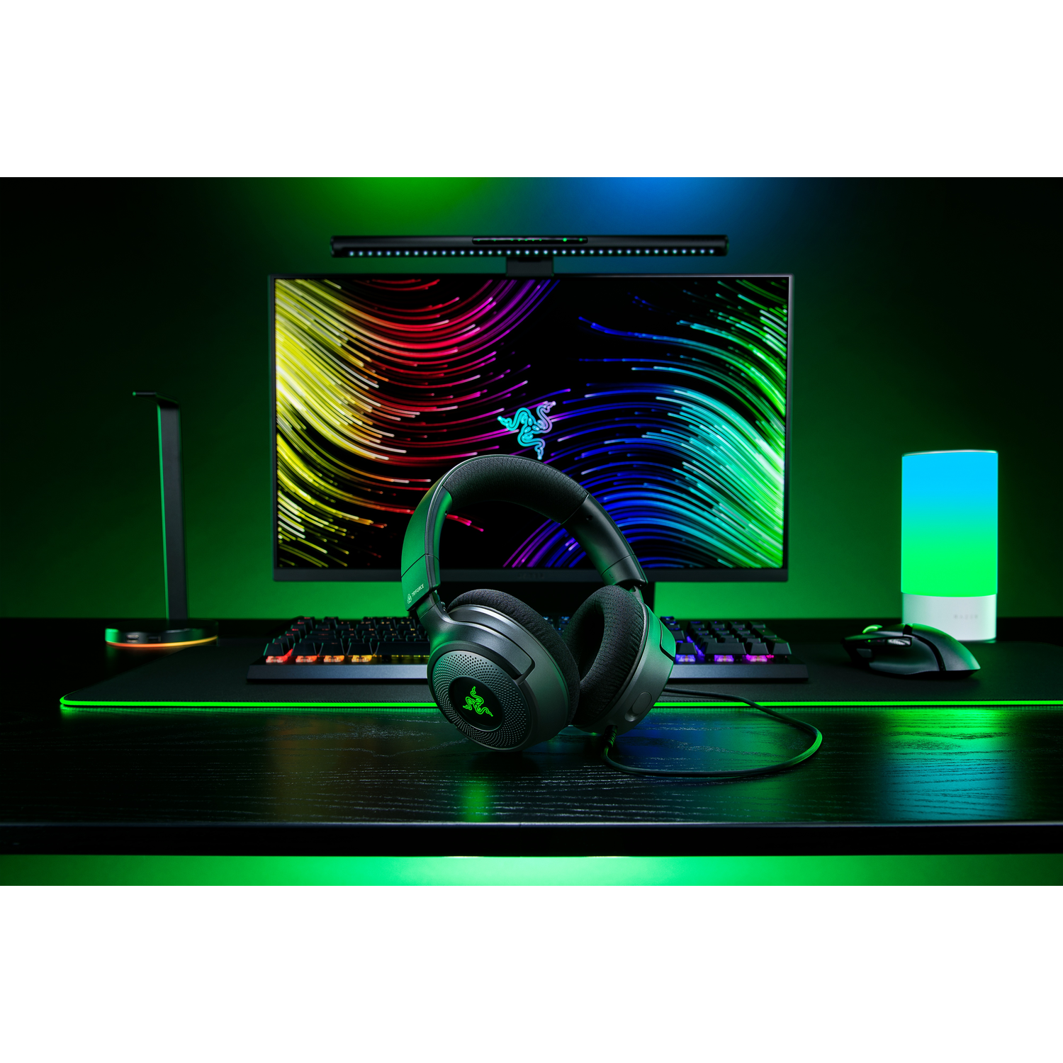 A gaming setup with headphones, a monitor, and a keyboard.