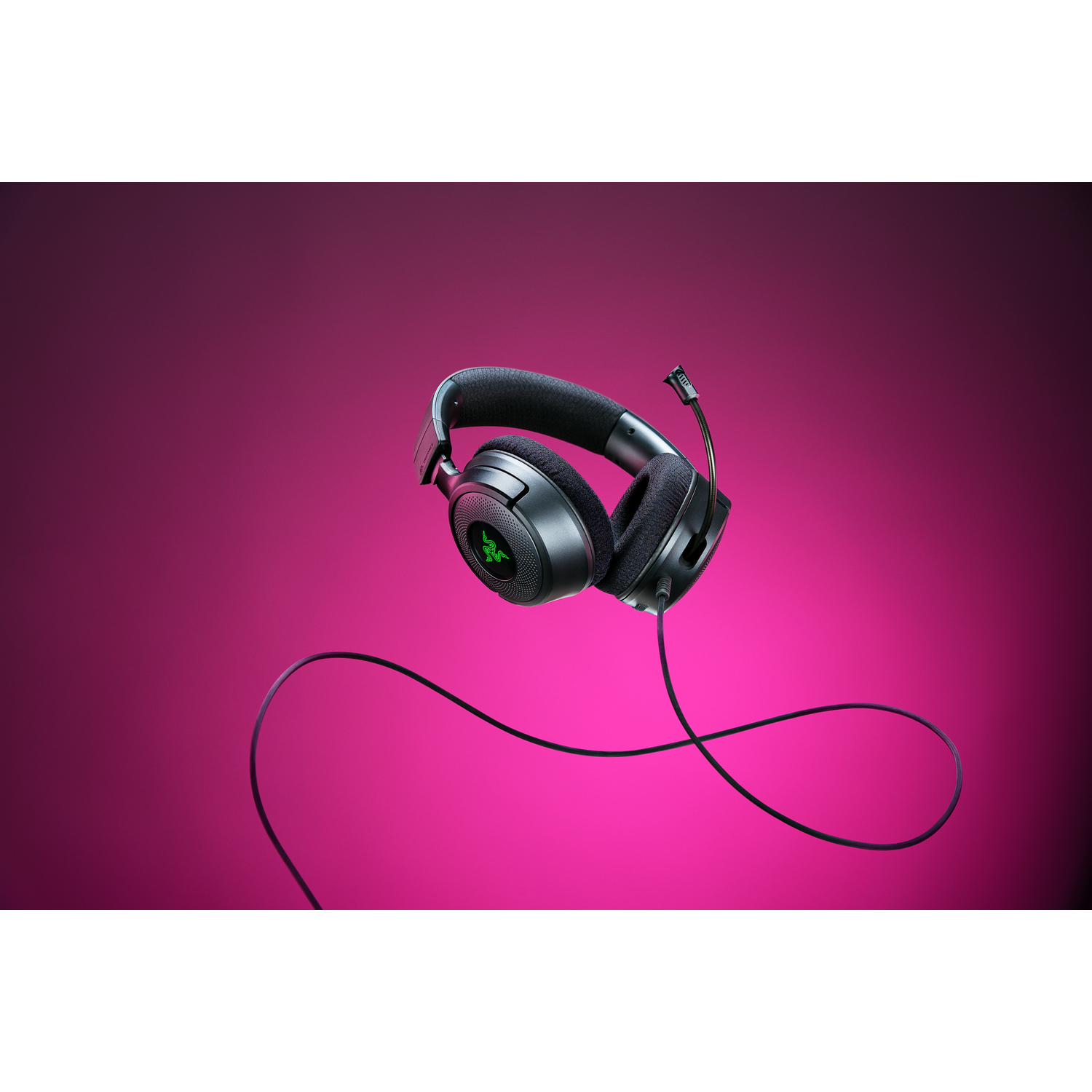 Black Razer headphones with a microphone, on a pink background.