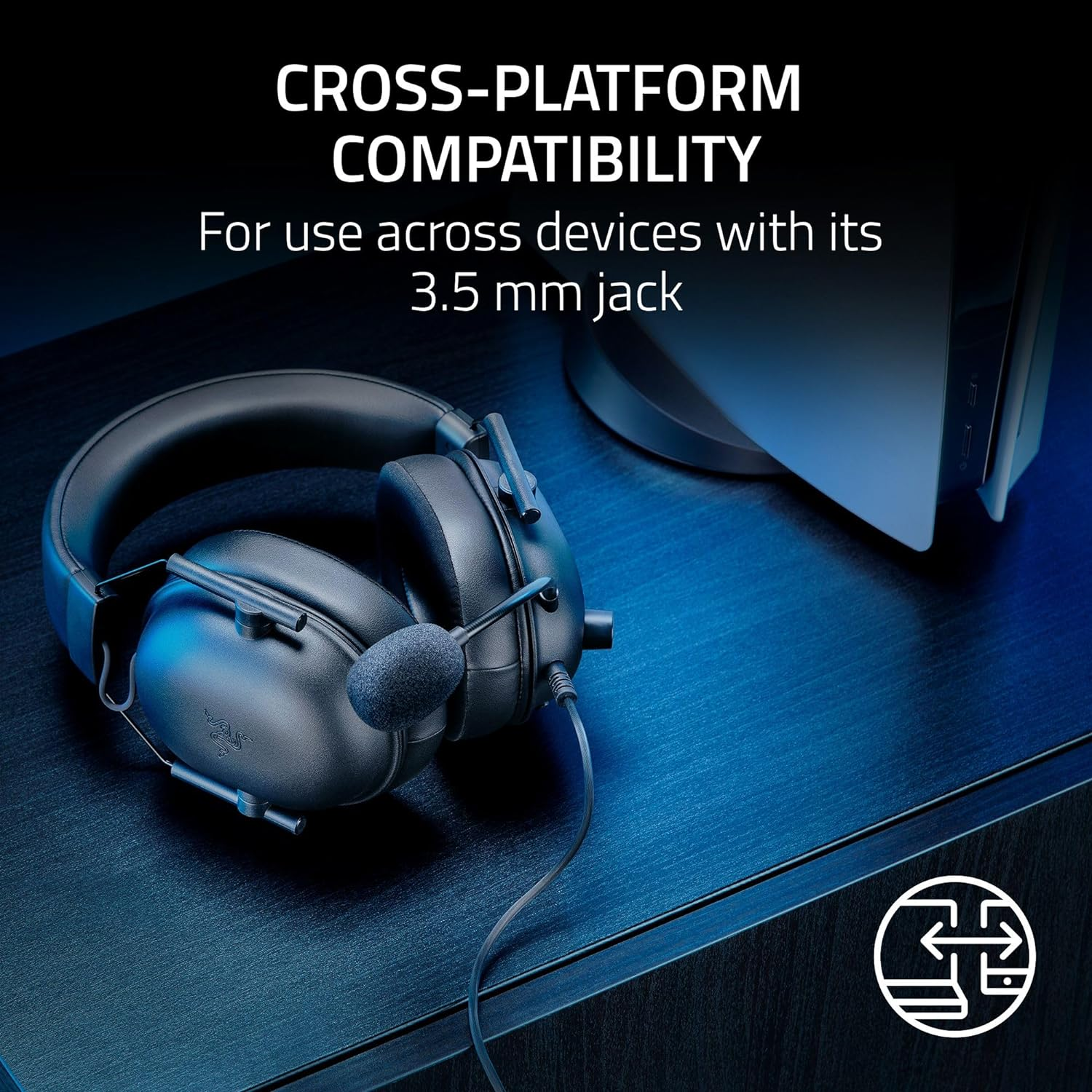 Black gaming headset with a microphone and a cable on a blue surface.