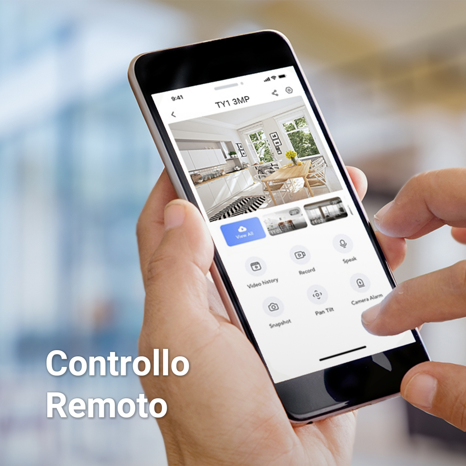Una mano che tiene uno smartphone che mostra un interno cucina moderno con icone di controllo remoto.