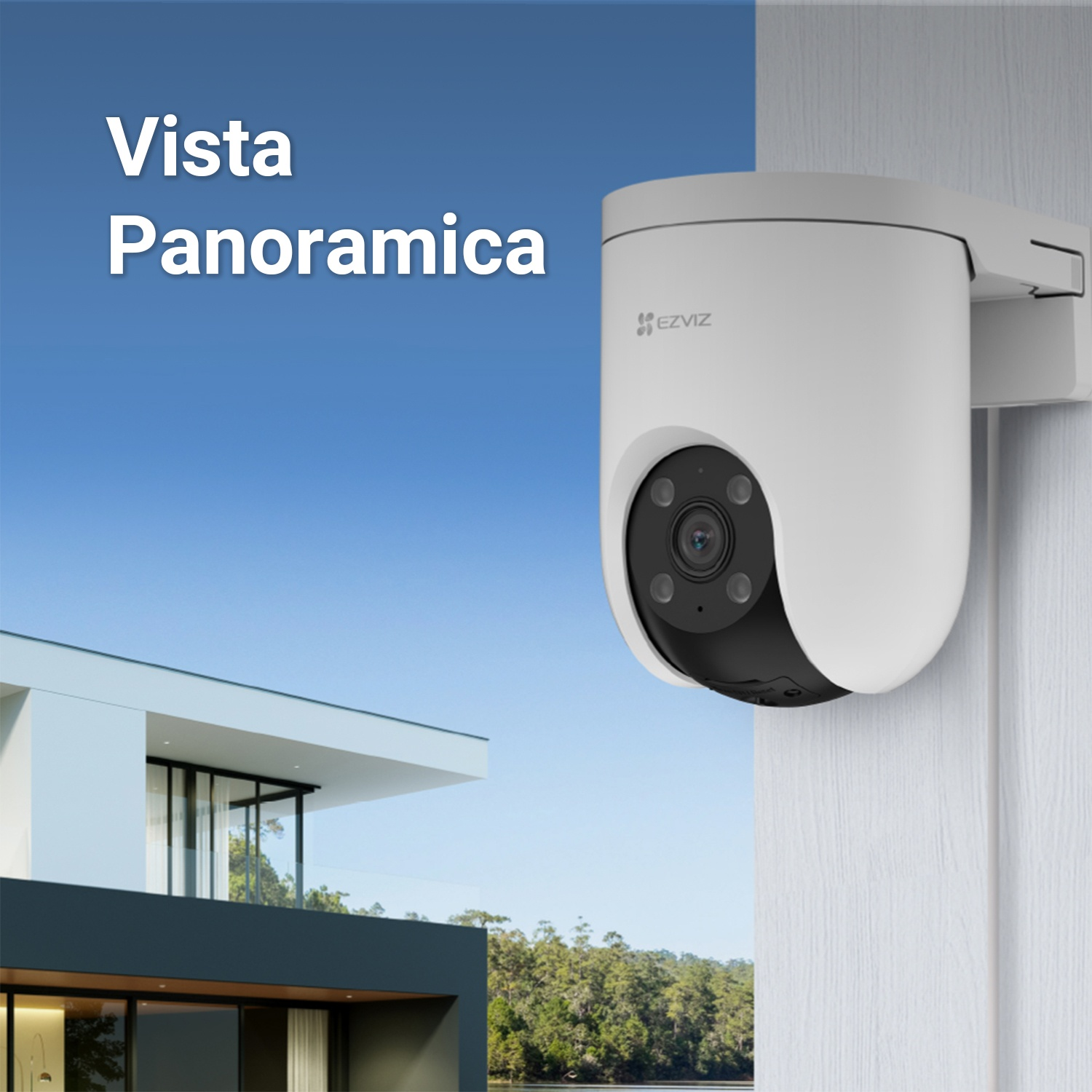 Telecamera di sicurezza bianca montata su un muro. Casa e cielo blu sullo sfondo.