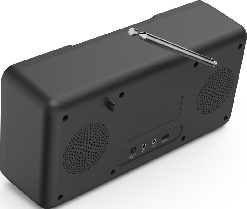 Une radio noire avec une antenne et des ports à l'arrière. Elle est sur une surface blanche.