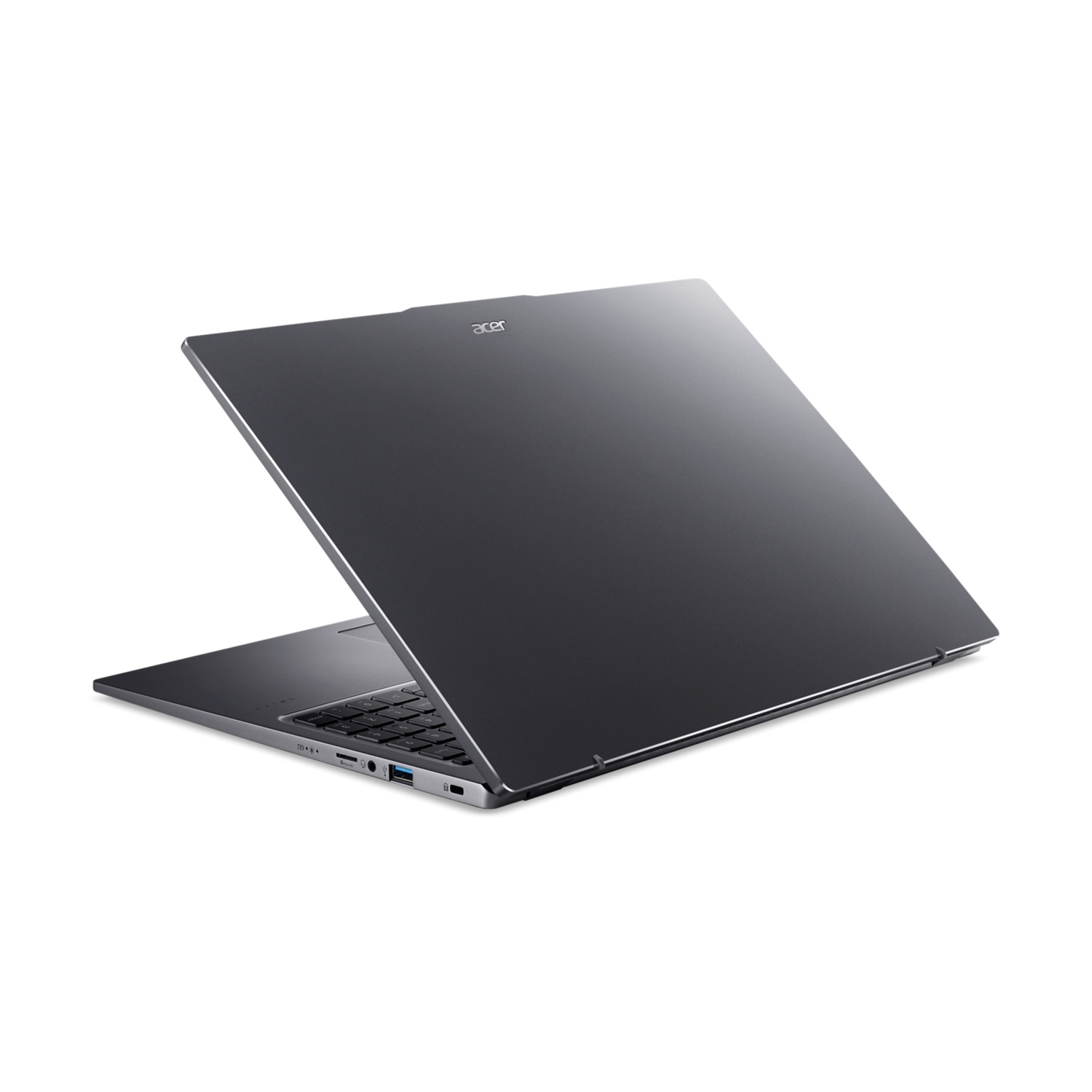 Un laptop grigio scuro è leggermente aperto su una superficie bianca. Il logo Acer è visibile.