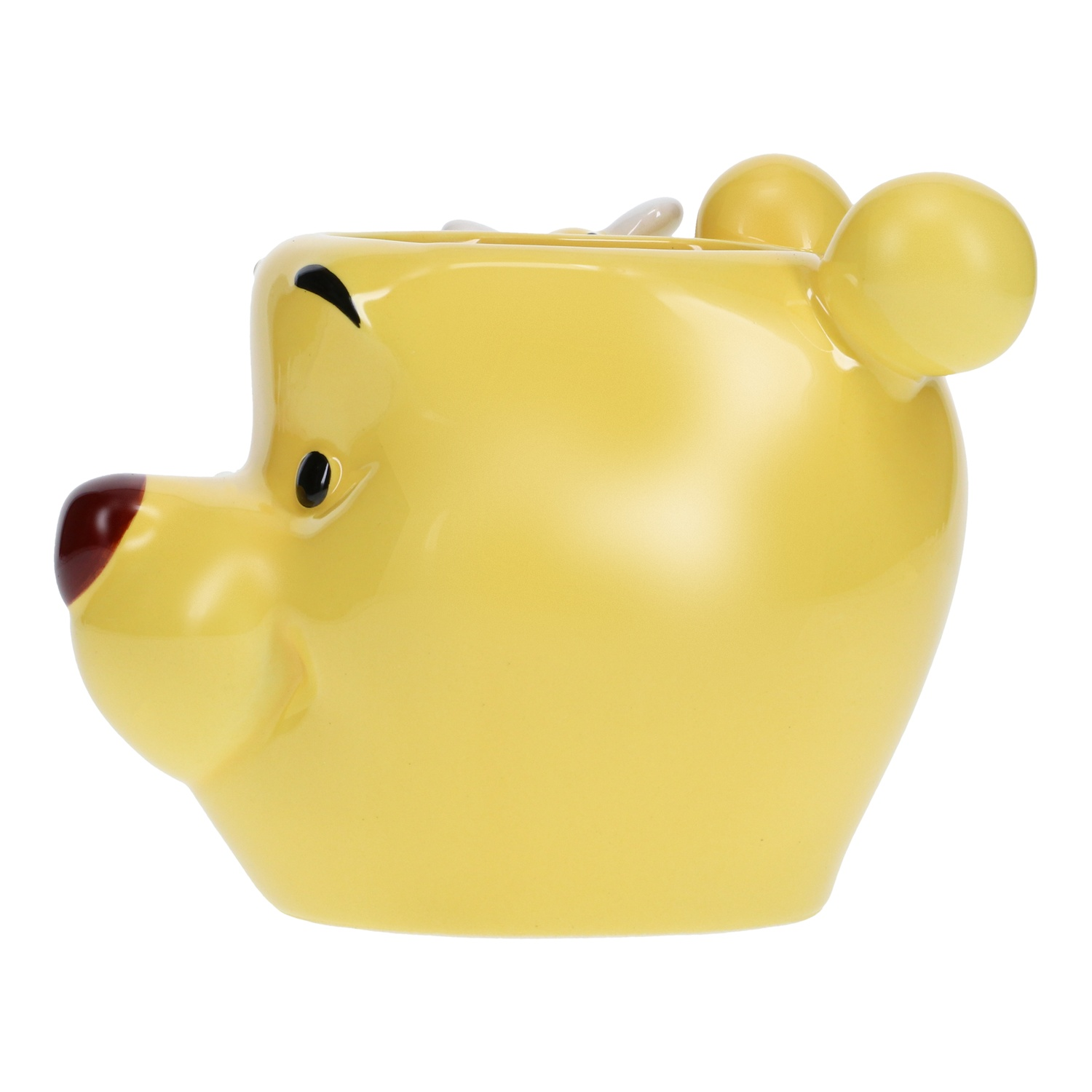 Yellow Winnie the Pooh shaped mug. It has a red nose and two ears. White background.