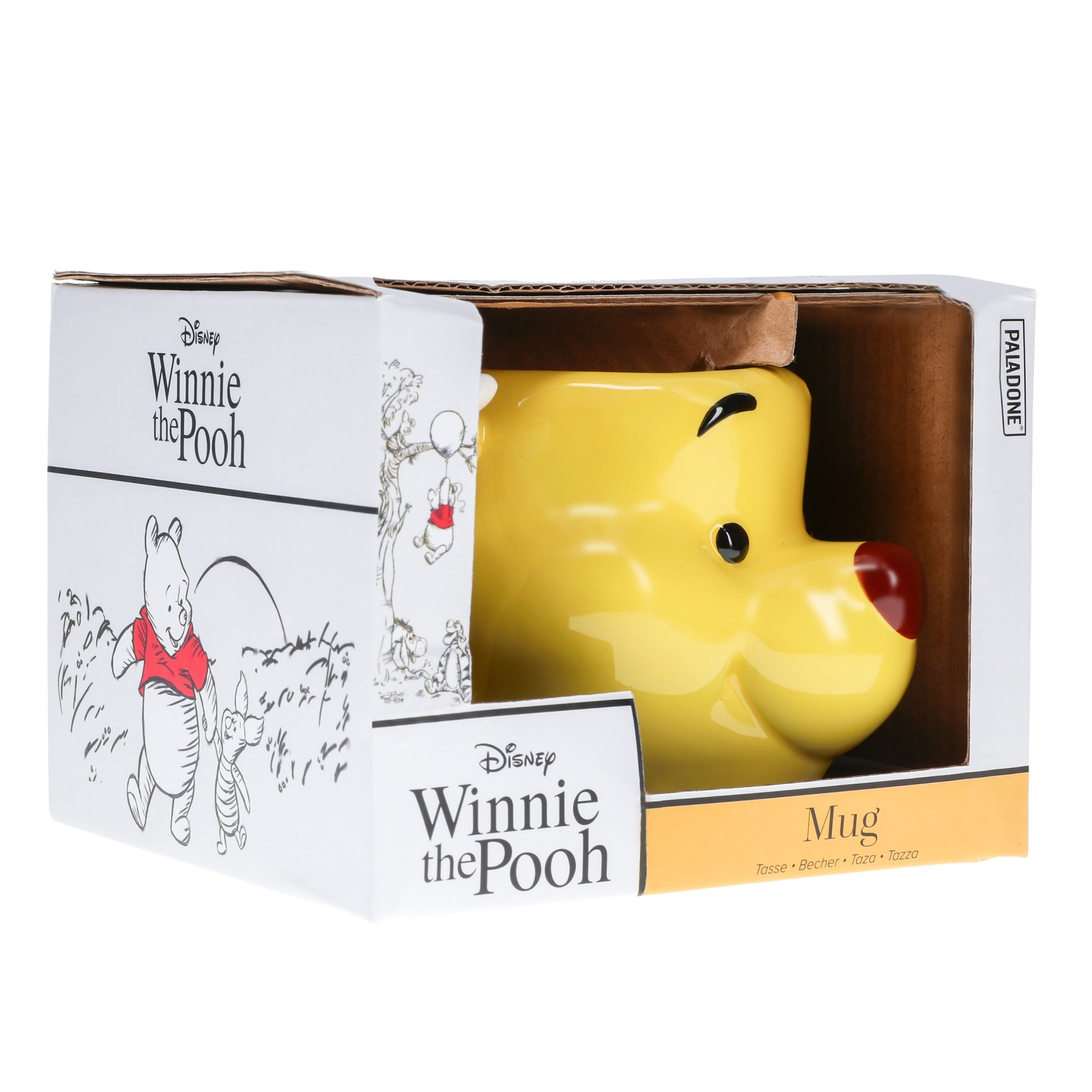 A Winnie the Pooh mug in a box. The mug is yellow with a Pooh face. The box is white and brown.