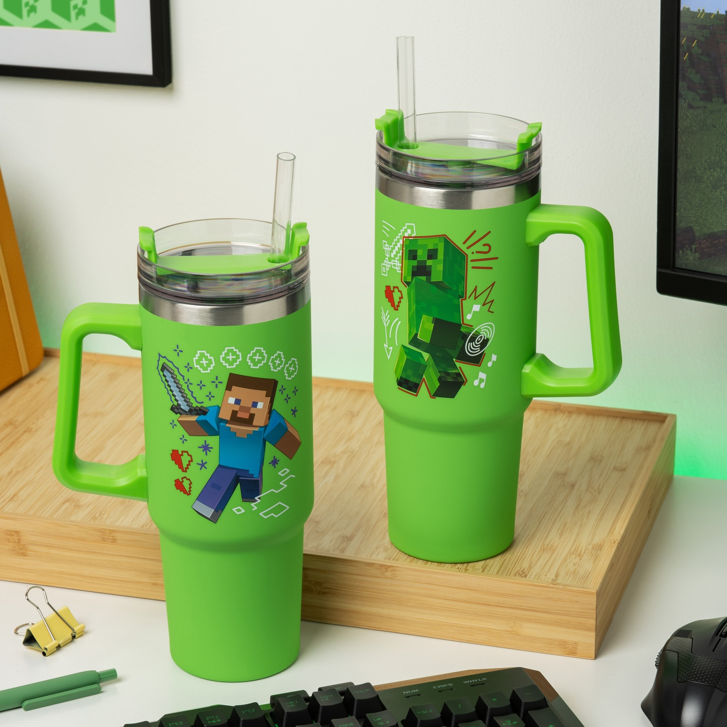 Two green Minecraft themed tumblers with straws. Both tumblers have different Minecraft characters.
