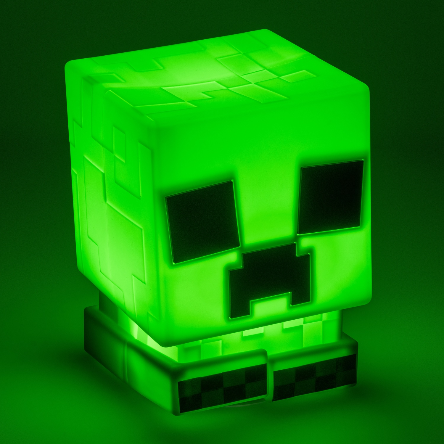 Green Minecraft Creeper light cube, glowing, black squares on face.