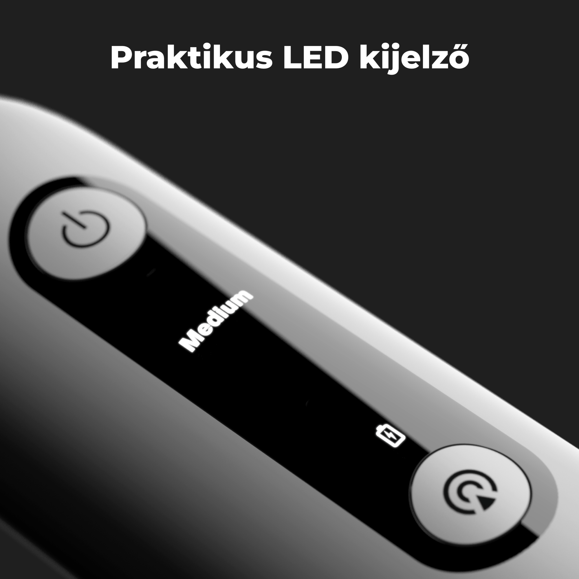 Egy szürke eszköz közeli képe, bekapcsológombbal, közepes jelzővel és töltési ikonnal.