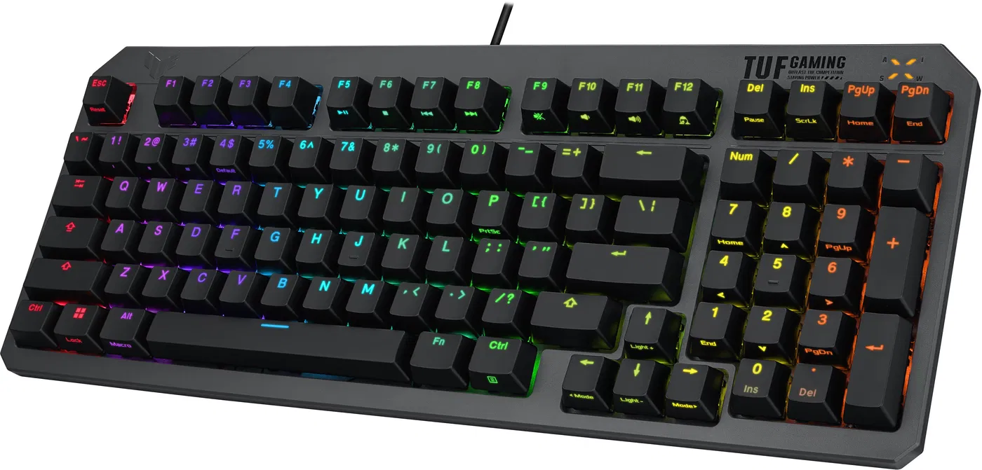 Fekete billentyűzet színes billentyűkkel. A billentyűzeten TUF Gaming logó és funkciógombok találhatók.