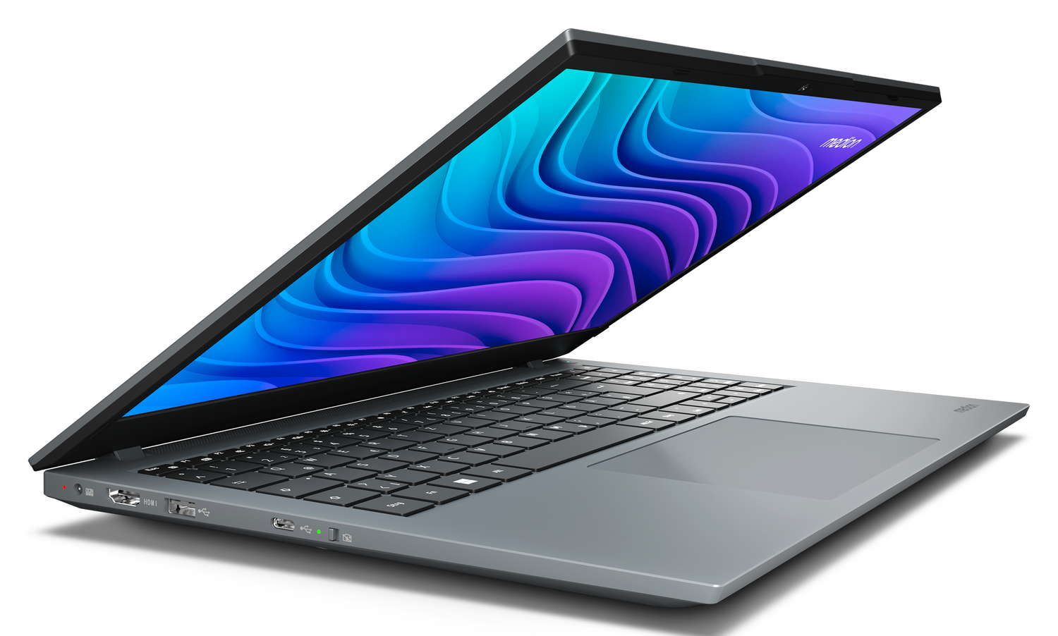 Una laptop gris con teclado negro está abierta. La pantalla muestra un diseño de olas azules y moradas. Fondo blanco.