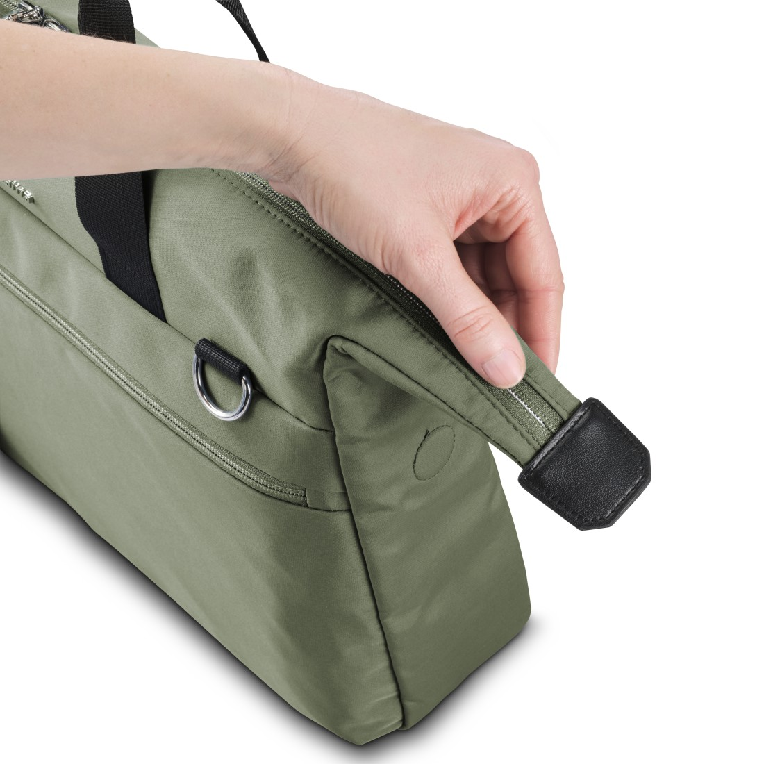 Hand berührt den Rand einer grünen Tasche und zeigt ein schwarzes Lederdetail.