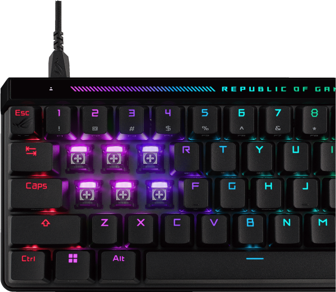 Egy gaming billentyűzet közeli képe, megvilágított gombokkal, különböző színekkel és az ROG logóval.