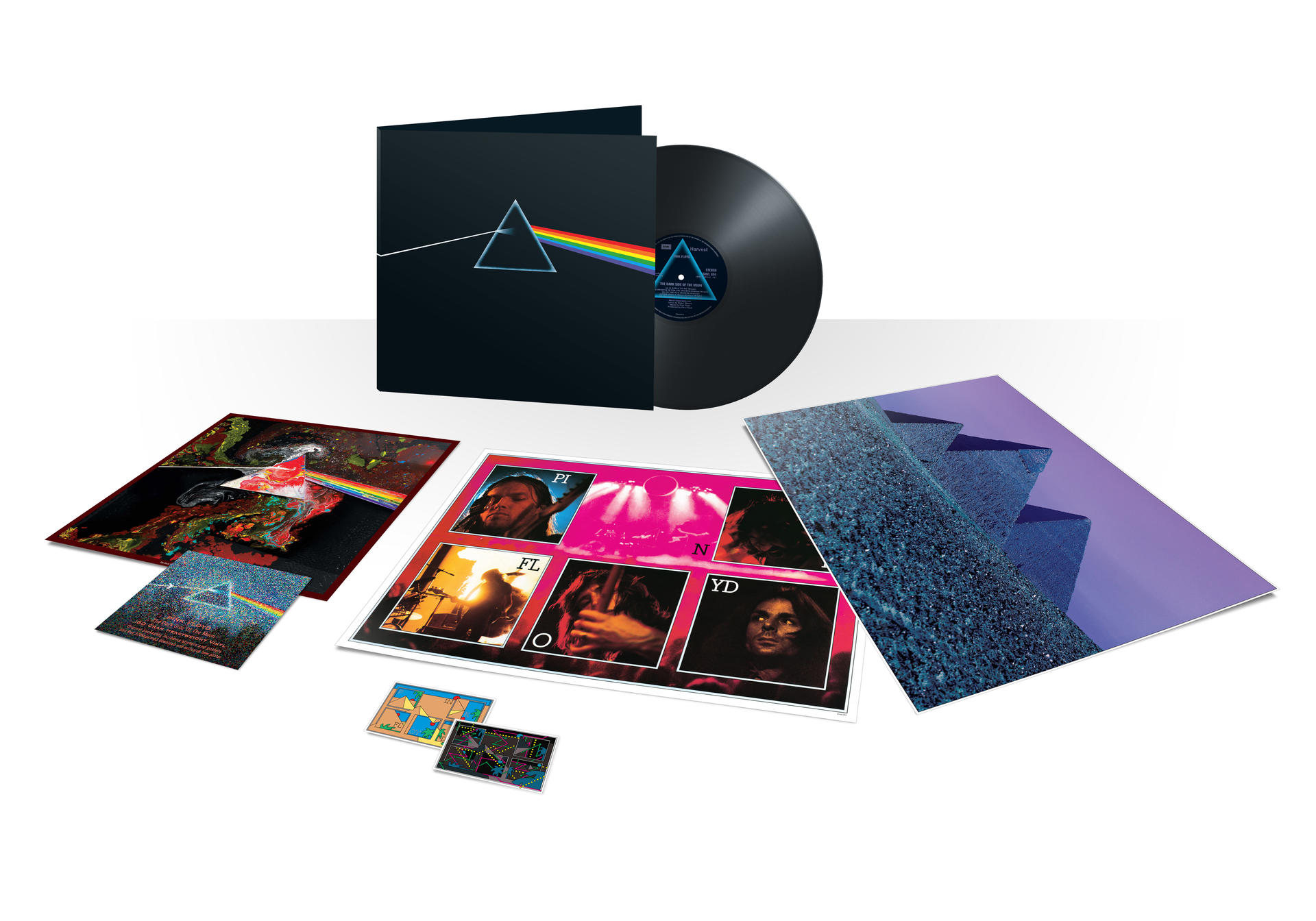Albumcover mit schwarzem Hintergrund und Vinyl-Schallplatte, mit Einlegern. Album-Artwork: Bandname, Titel und Dreieck.