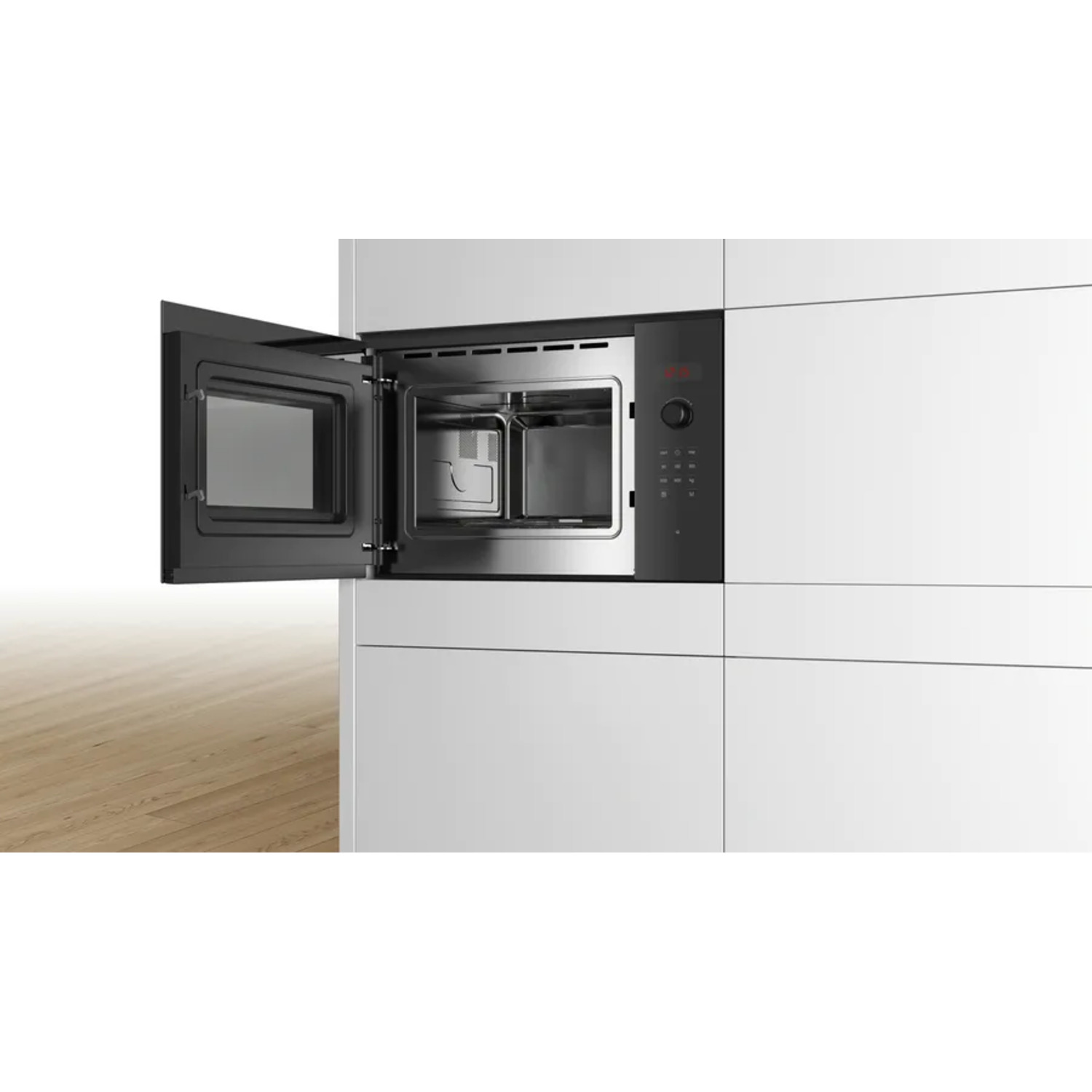 Open microwave oven in a white kitchen.
