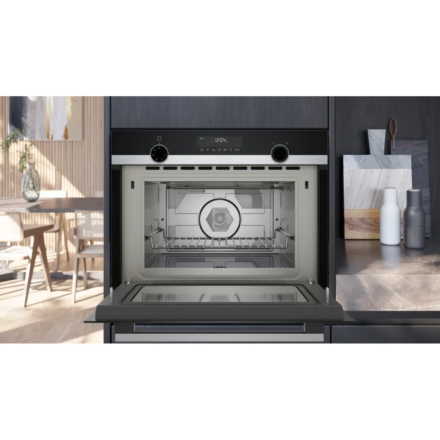 Black oven with a digital display showing time. The oven is open, revealing its interior.