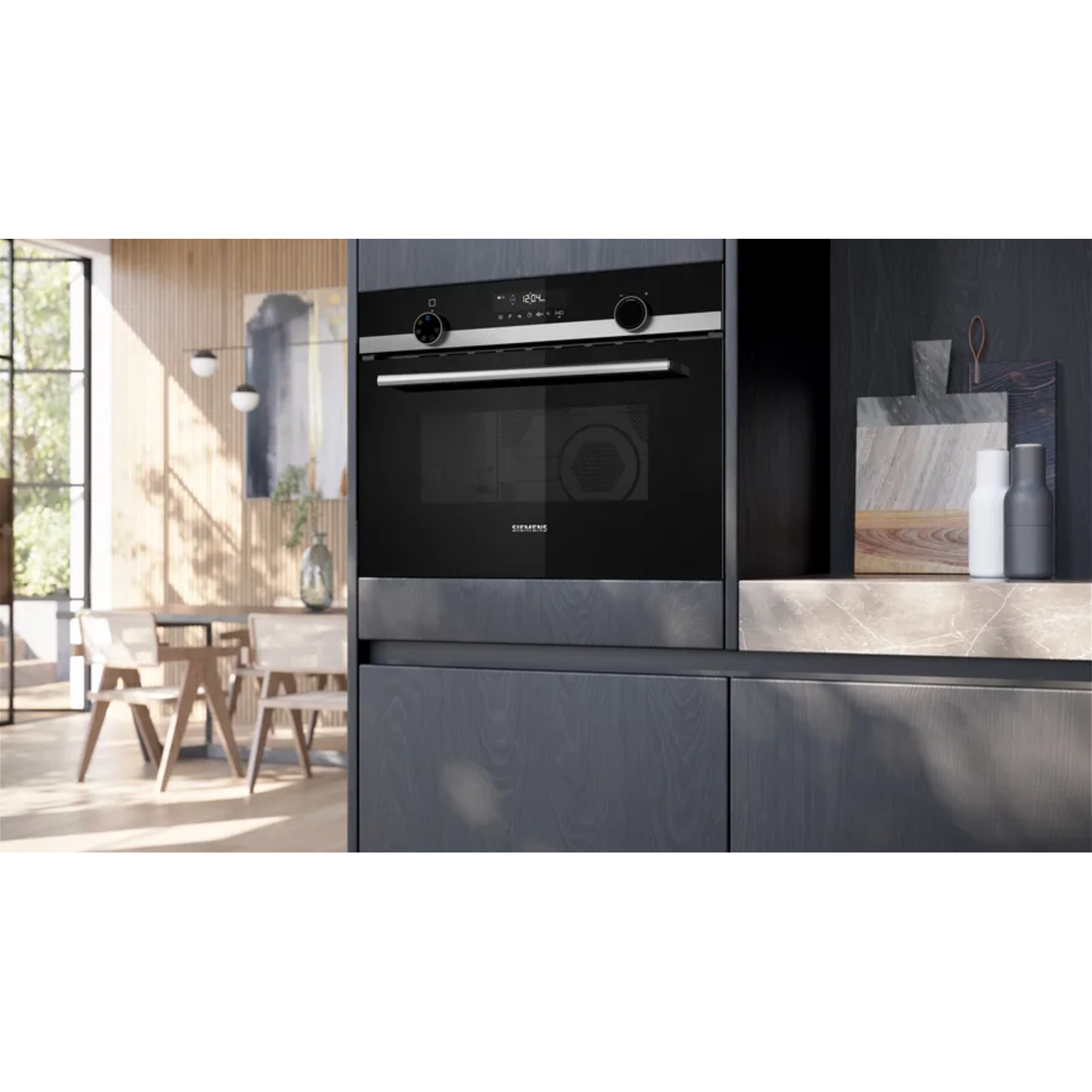 Built-in black oven with digital display, in a modern kitchen setting.