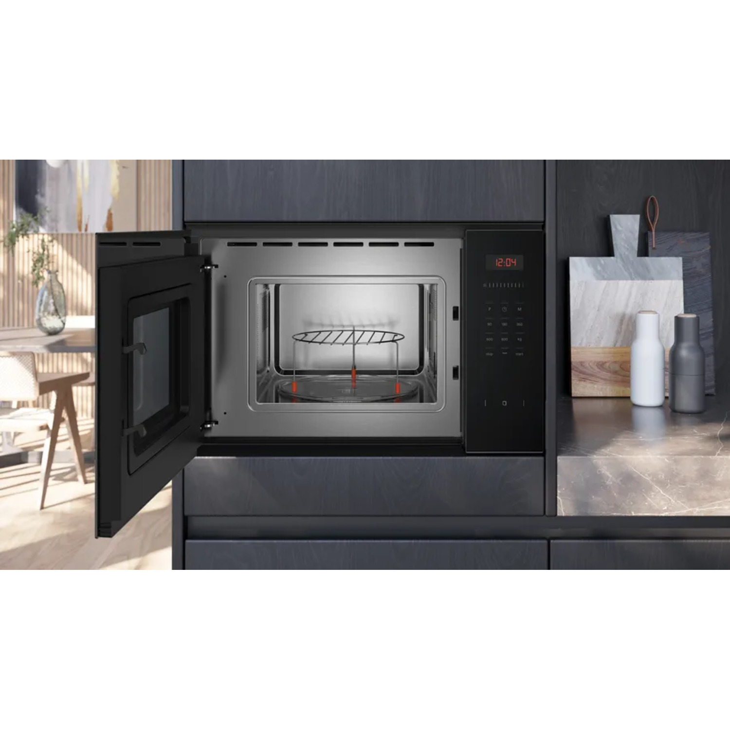 An open black microwave shows a glass plate and a wire rack.