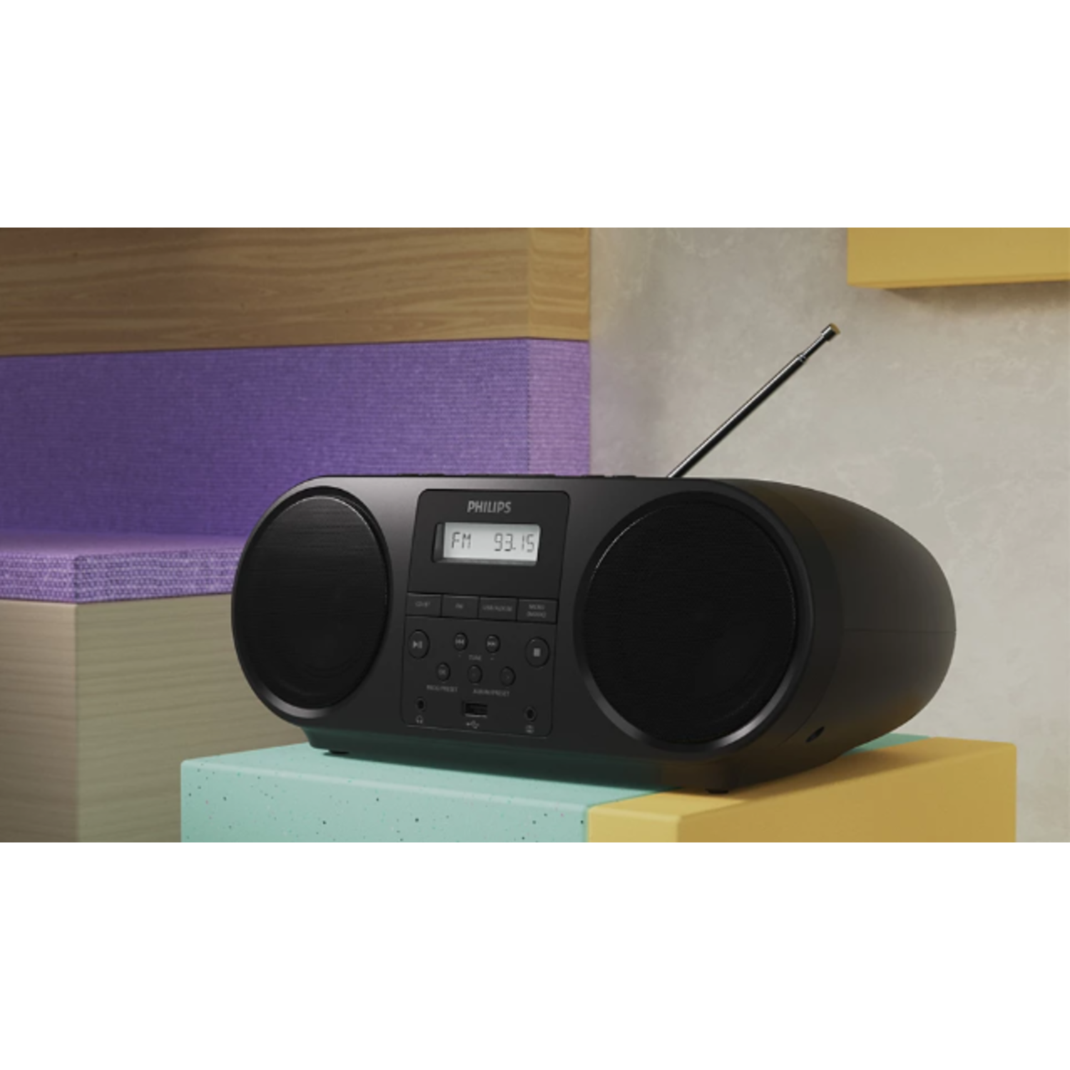 Een zwarte boombox met twee luidsprekers en een antenne staat op een kleurrijk display.