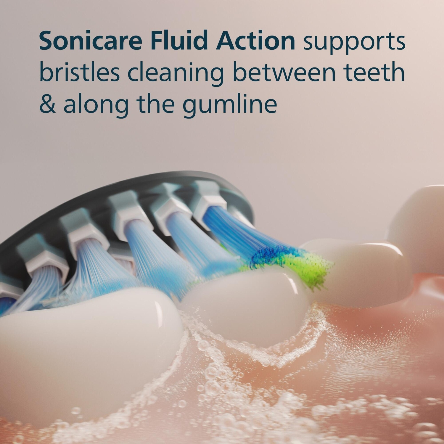Close-up of toothbrush cleaning teeth. Blue and green bristles are visible, along with water droplets.