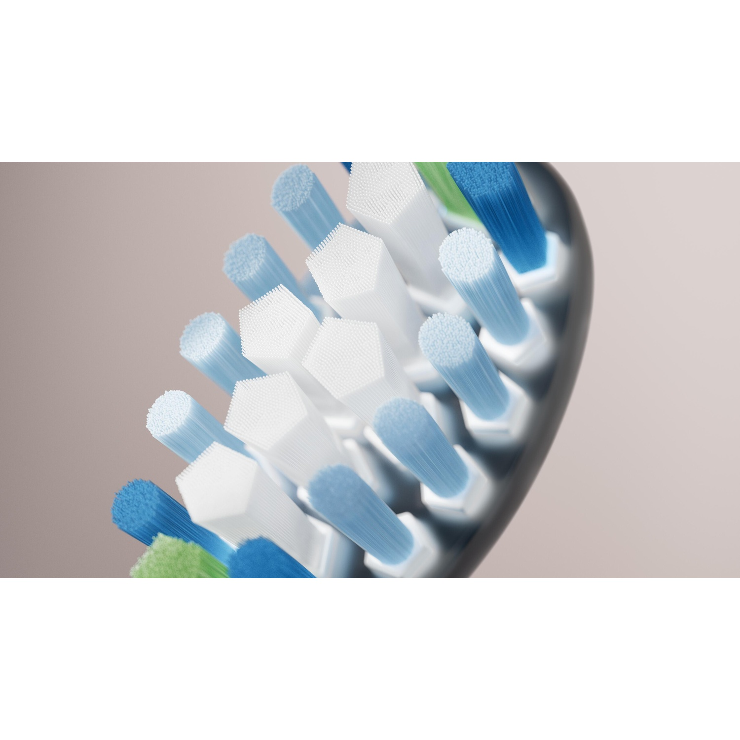 Close-up of toothbrush head bristles. White, blue, and green bristles. Black backing. Neutral, blurred background.