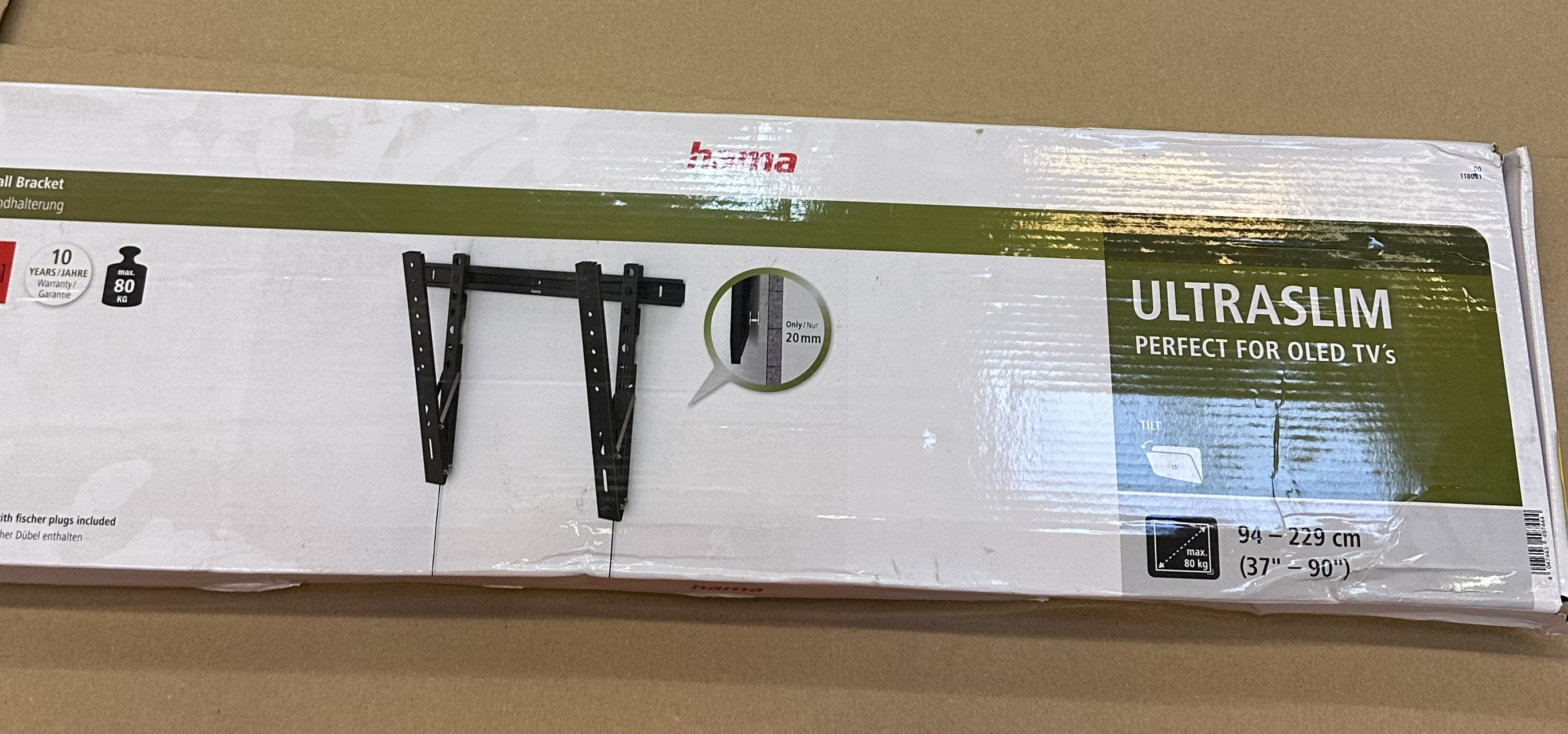 Białe pudełko z czarnym uchwytem TV, tekstem 'ULTRASLIM' i szczegółami. 10 lat gwarancji.