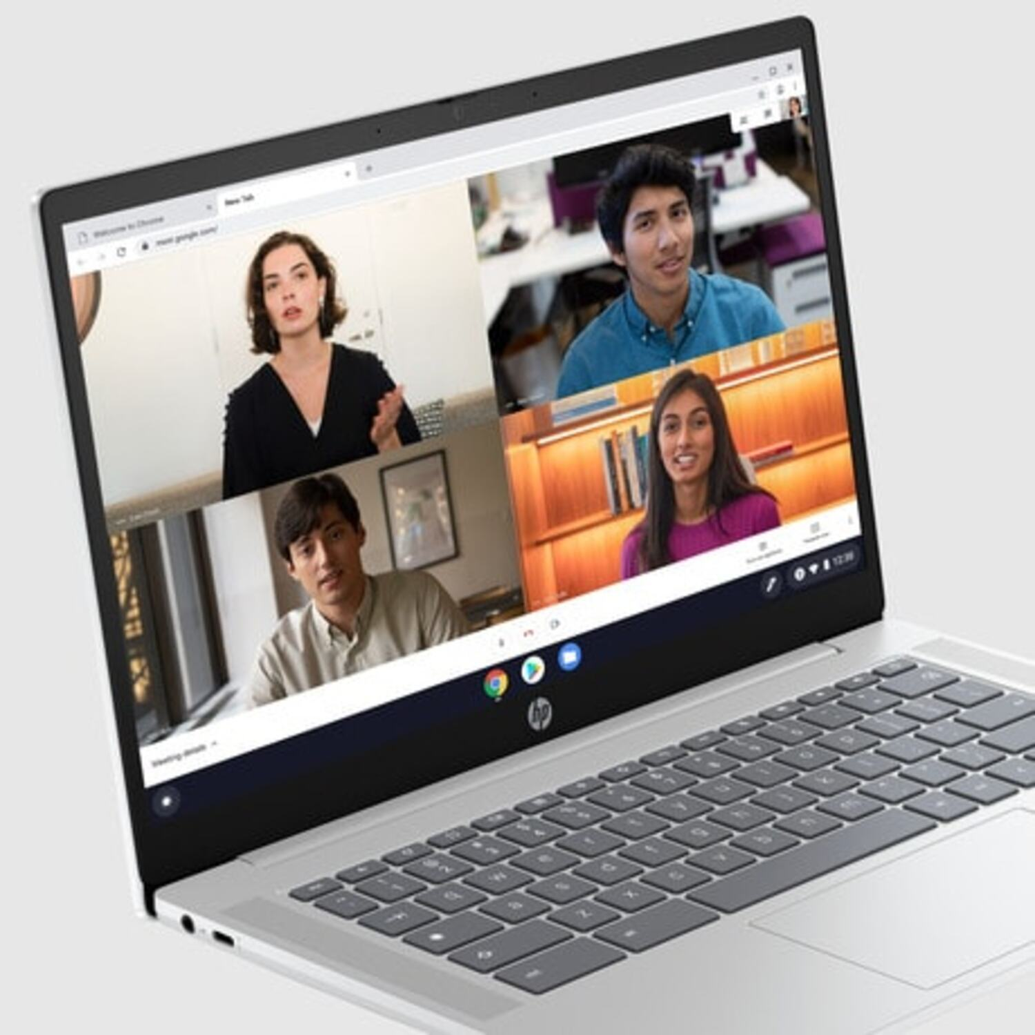 Laptop screen showing a video call with four people, and the chrome browser.