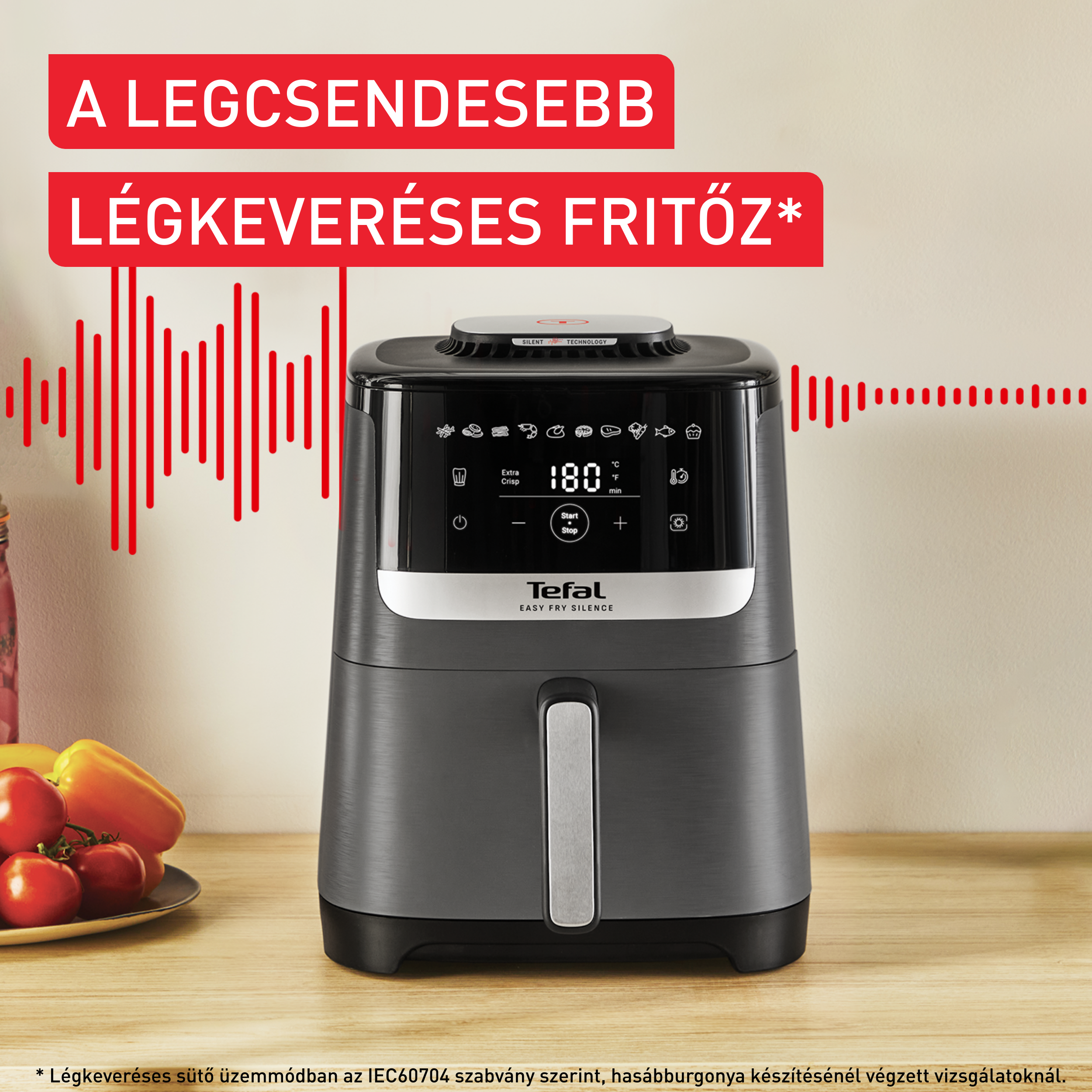 Levegősütő, szöveggel, hanghullám grafikával és zöldségekkel a faasztalon.