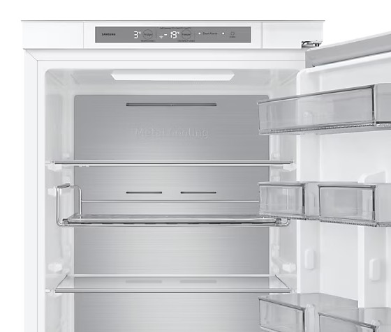 Wnętrze białej lodówki z półkami i szufladami.