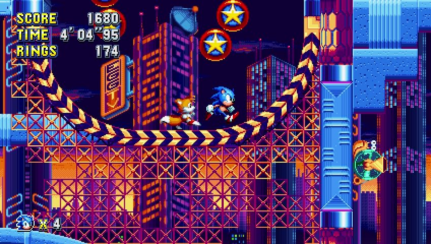 Eine Videospielszenen mit Sonic und Tails, die auf einer Strecke mit Gebäuden und Sternen laufen.