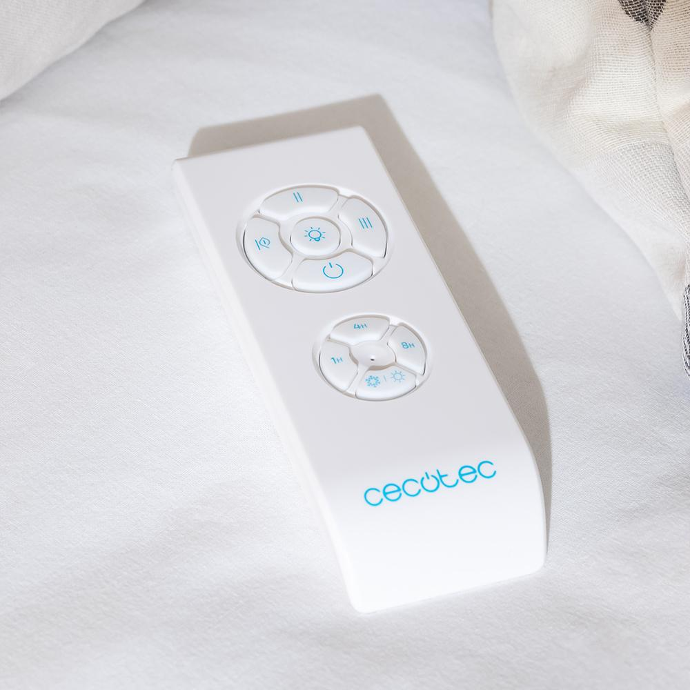 Un mando a distancia blanco con botones azules y el logo de Cecotec descansa sobre tela blanca.