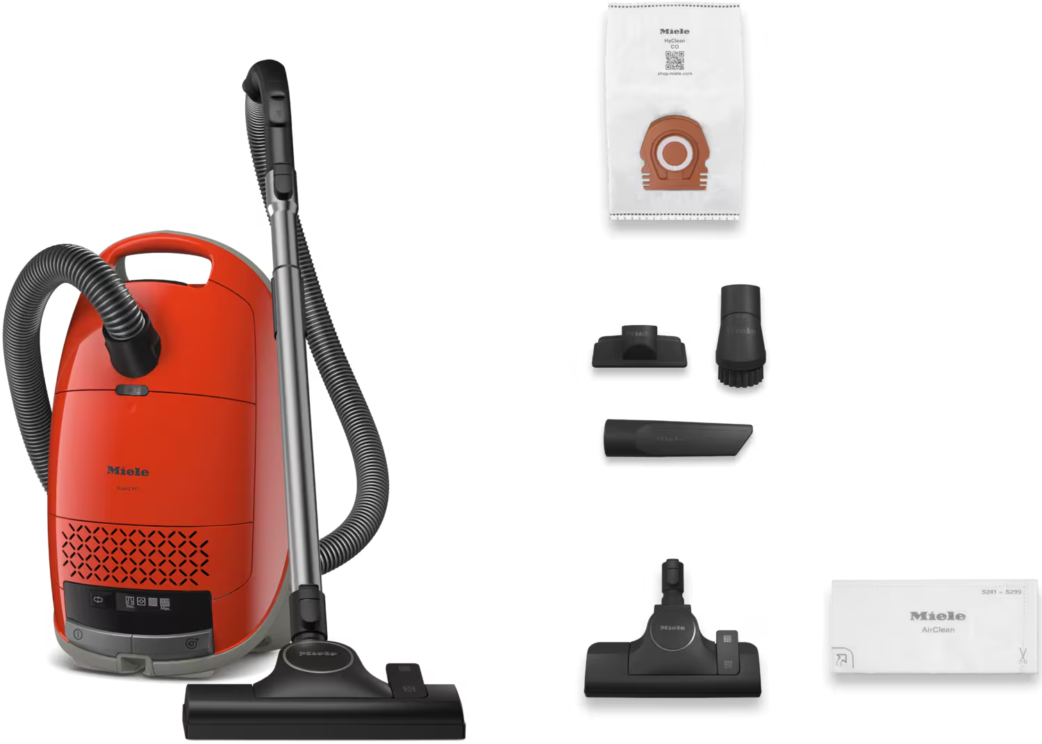 Aspirateur Miele rouge avec accessoires et un sac. Fond blanc.