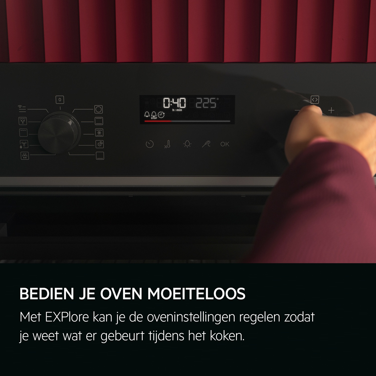 Hand touching oven control panel. Digital display shows time and temperature. Red panel background.