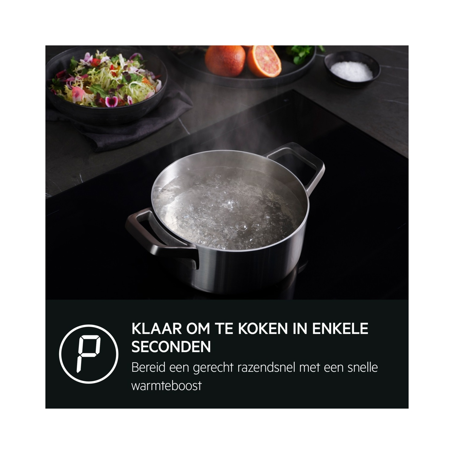 Boiling water in a pot on a cooktop. Salad in a bowl and grapefruit on the side.