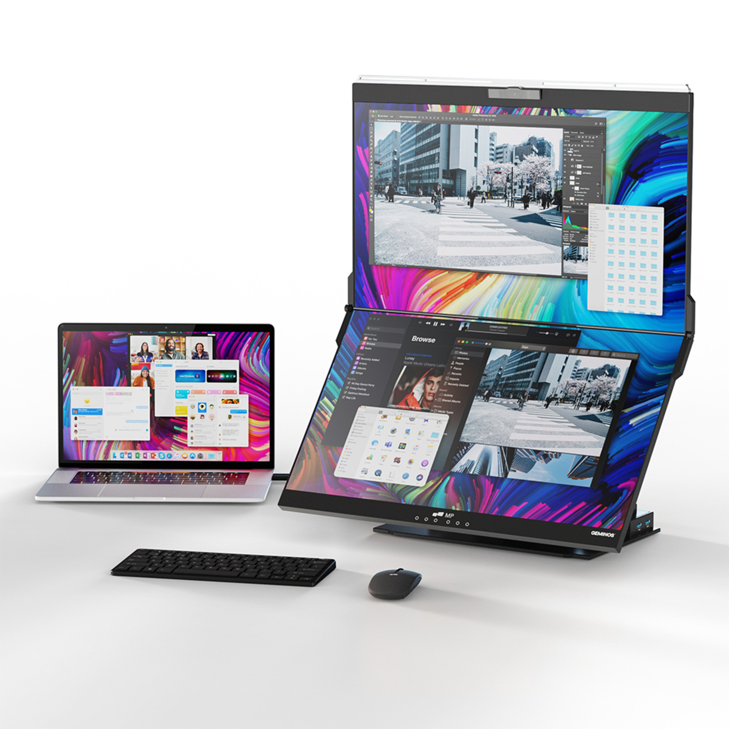 A laptop, keyboard, and a multi-screen monitor setup.