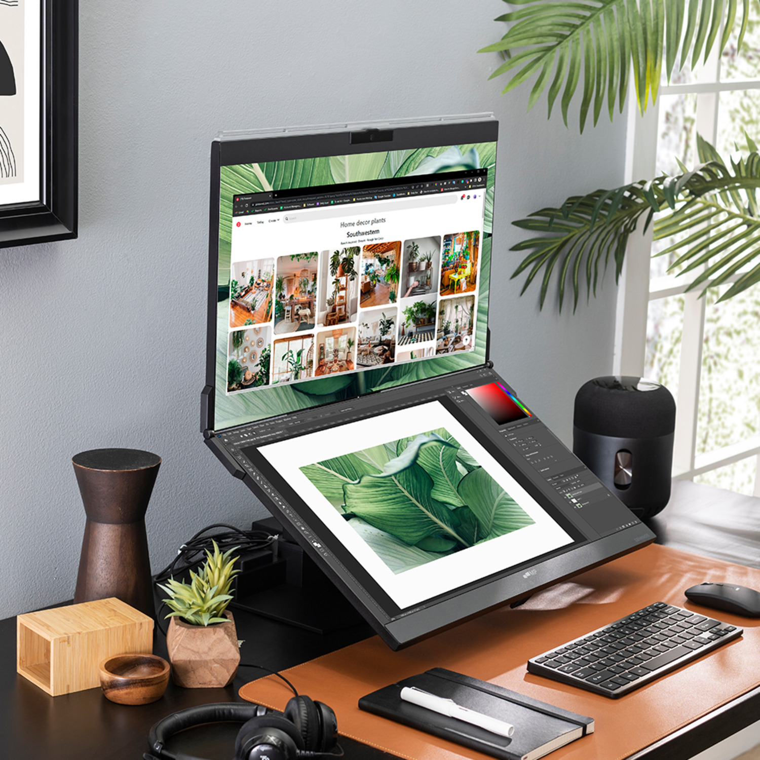 Workstation setup with dual monitor, keyboard, mouse, accessories, and plants.